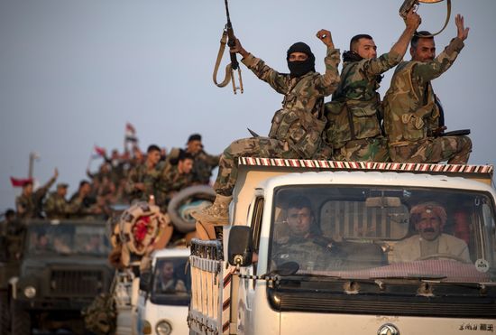 Syrian government forces drive along a road in the countryside of the northeastern Syrian city of Qamishli on October 25, 2019. - Damascus and Moscow deployed extra forces to Syria's border with Turkey, even as Washington partially reversed a drawback to boost its own military presence near key Syrian oil fields. (Photo by - / AFP) (Photo by -/AFP via Getty Images)